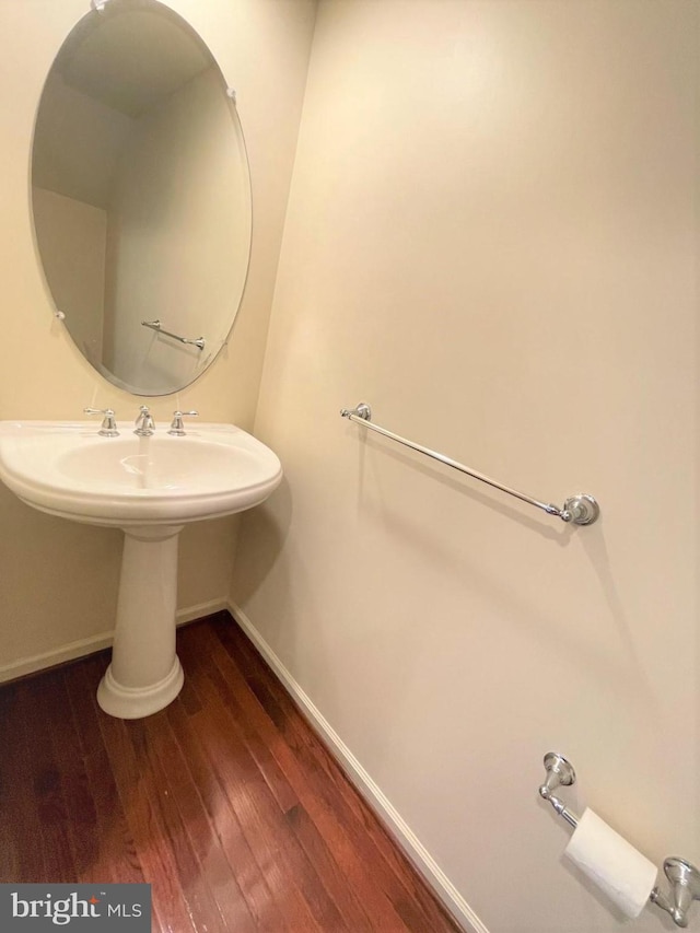 bathroom with hardwood / wood-style floors