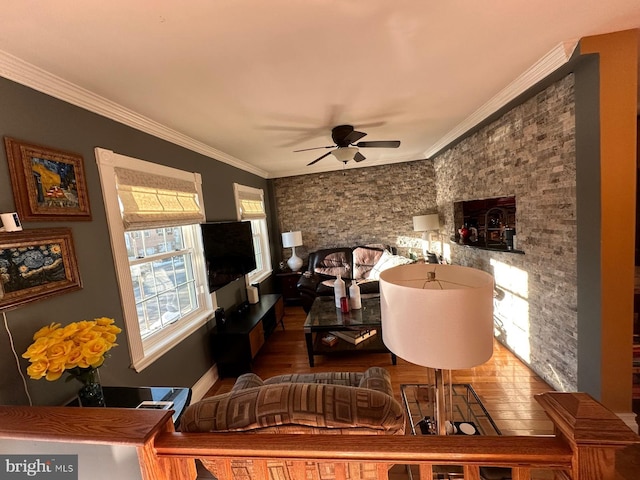 living room with crown molding, ceiling fan, and hardwood / wood-style flooring