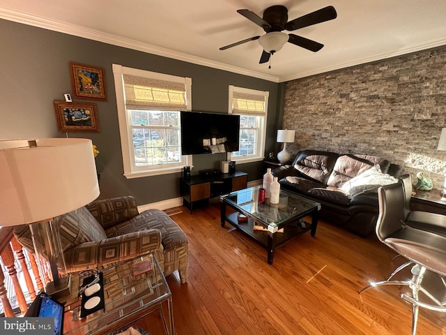 living room with hardwood / wood-style flooring, crown molding, and ceiling fan