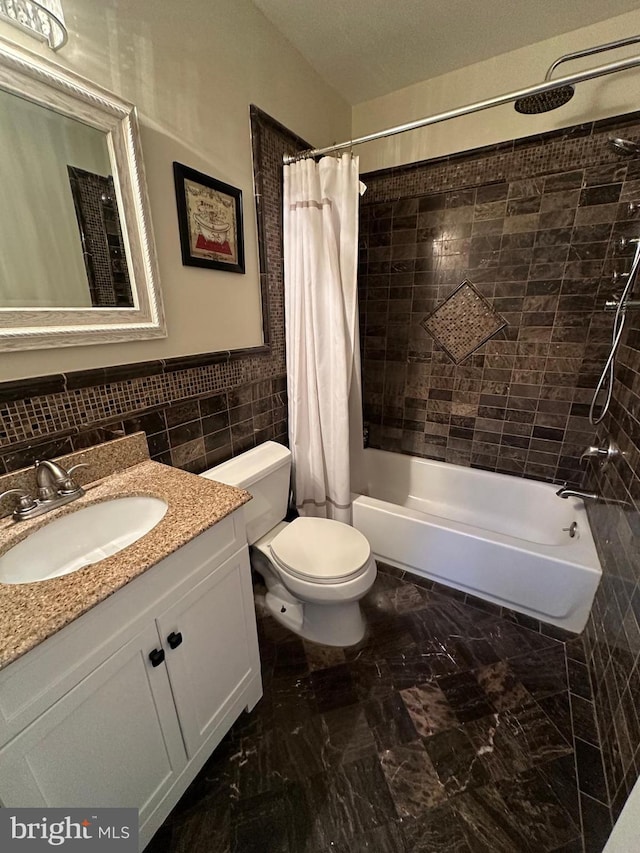 full bathroom featuring tile walls, vanity, shower / bath combination with curtain, and toilet