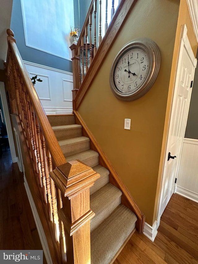 staircase with wood-type flooring