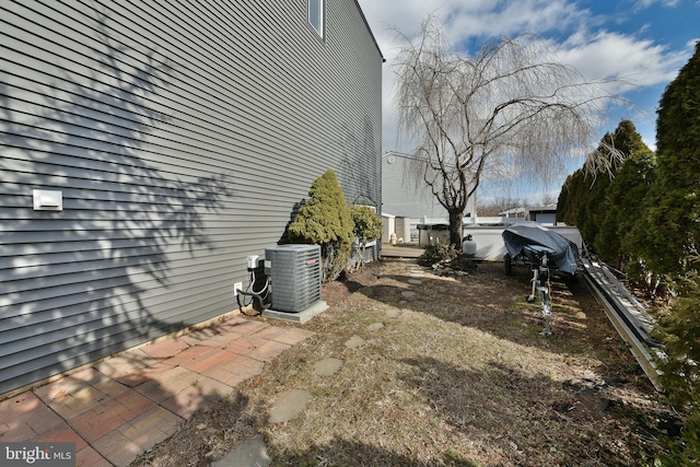 view of yard featuring central air condition unit