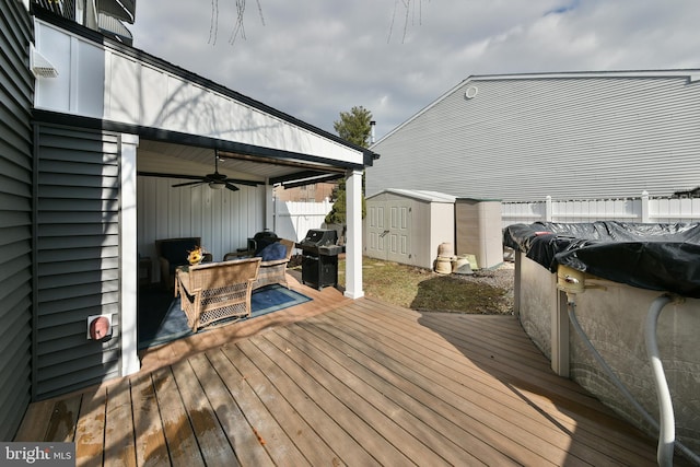 wooden deck with a grill, ceiling fan, and a storage unit