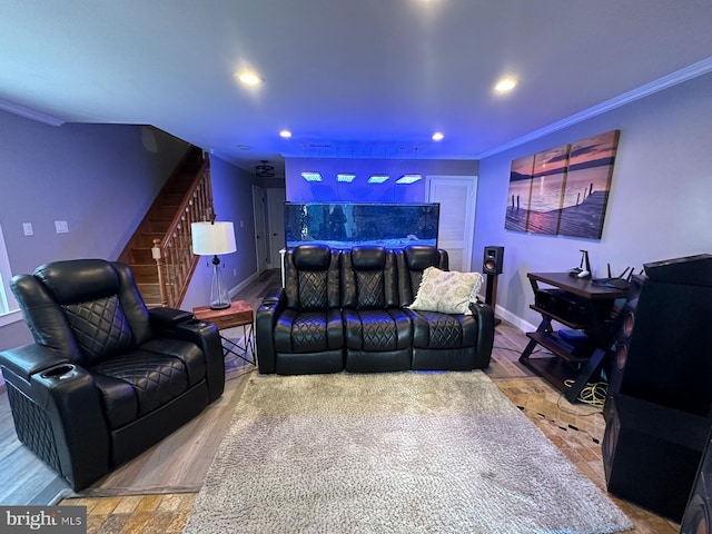 home theater room with crown molding and hardwood / wood-style floors