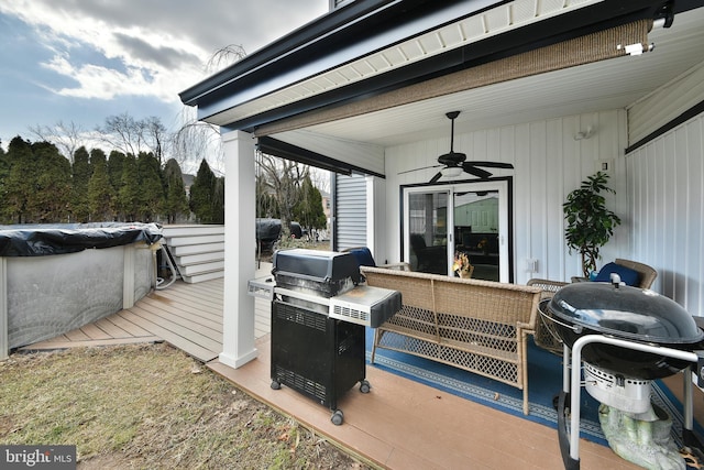 view of patio / terrace featuring area for grilling, an outdoor living space, ceiling fan, and a swimming pool side deck