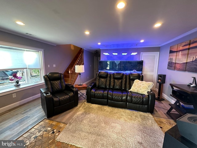 home theater featuring wood-type flooring and ornamental molding