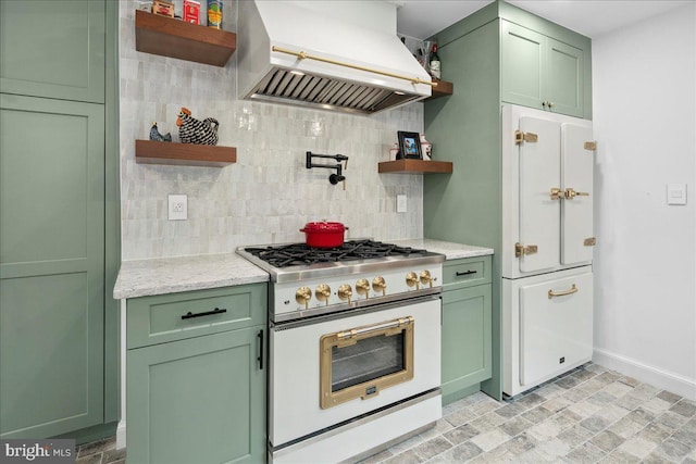 kitchen with white appliances, premium range hood, backsplash, light stone countertops, and green cabinetry