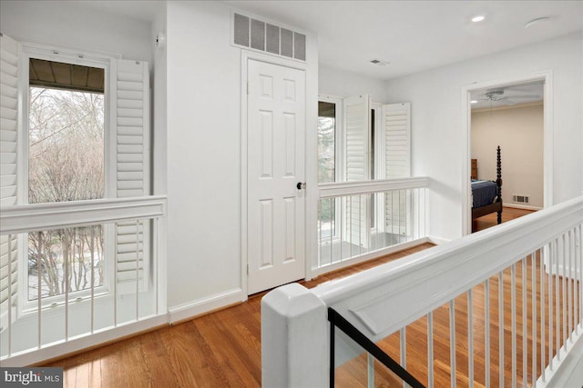 hall with hardwood / wood-style floors