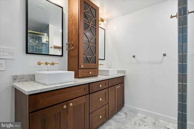 bathroom with walk in shower and vanity