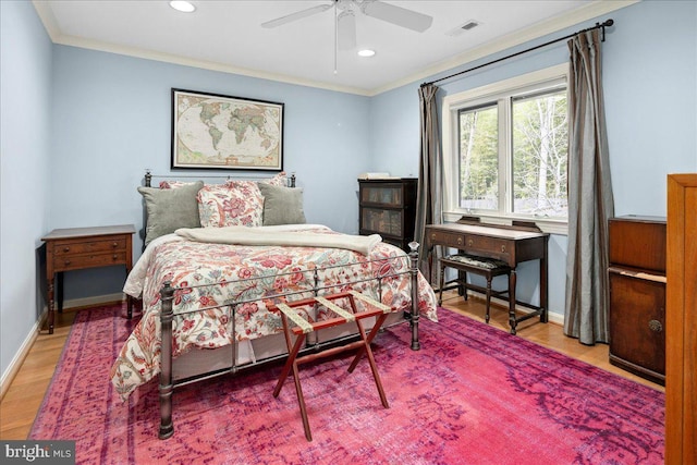 bedroom featuring ornamental molding, wood-type flooring, and ceiling fan