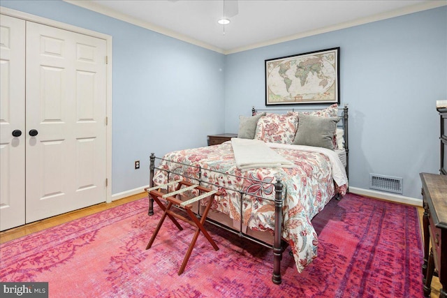 bedroom with crown molding and hardwood / wood-style floors