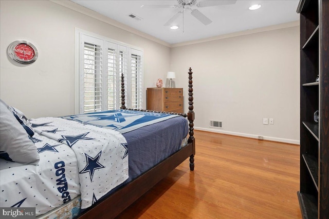 bedroom featuring hardwood / wood-style floors, crown molding, and ceiling fan