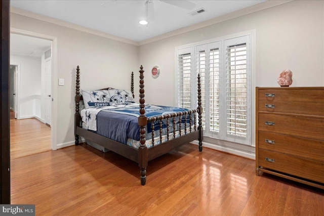 bedroom with ornamental molding, hardwood / wood-style floors, and ceiling fan