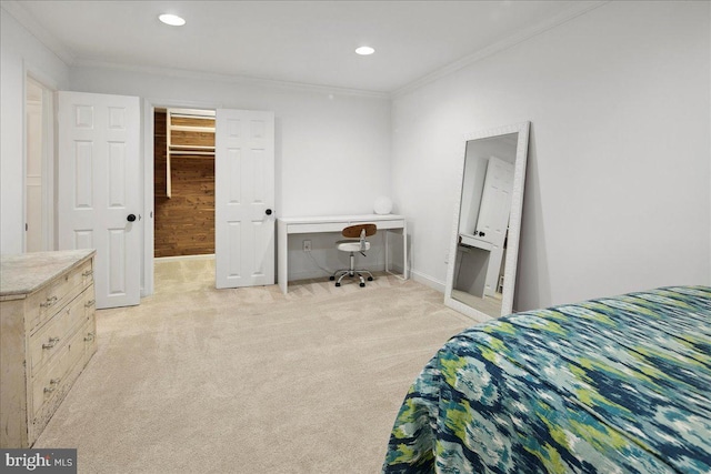 carpeted bedroom with crown molding and a walk in closet