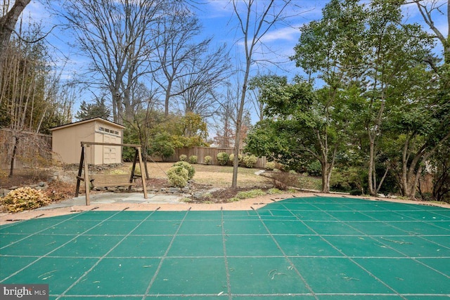 view of swimming pool featuring a shed