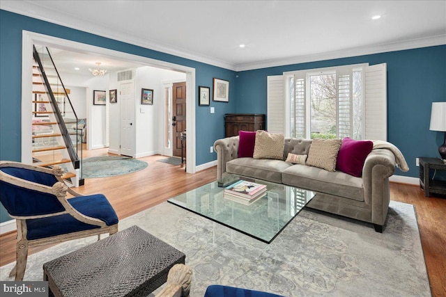 living room with crown molding and hardwood / wood-style floors