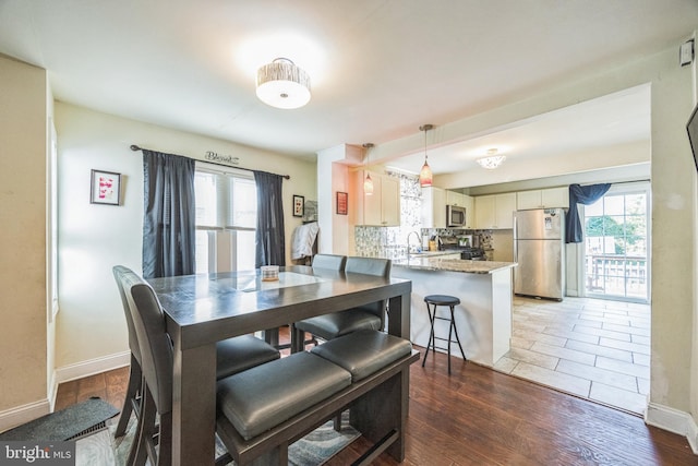 dining area featuring dark wood-type flooring and sink