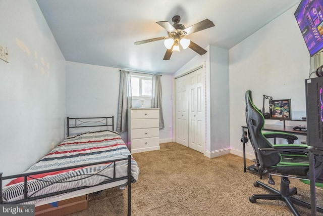 carpeted bedroom with lofted ceiling, ceiling fan, and a closet