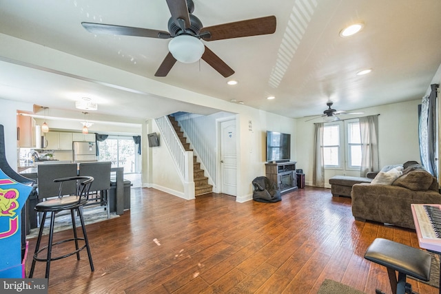 living room featuring dark wood-type flooring and a wealth of natural light