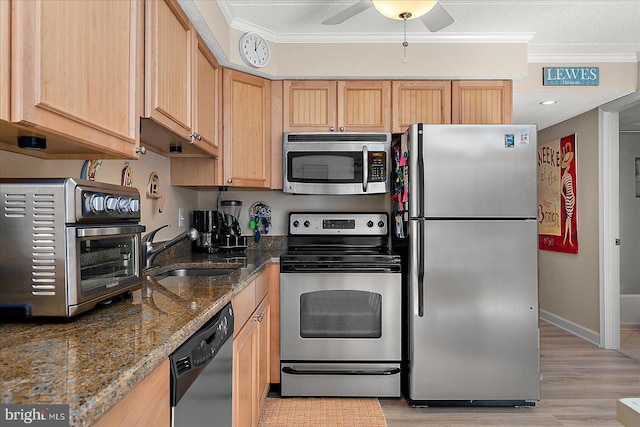 kitchen featuring appliances with stainless steel finishes, sink, and light brown cabinetry