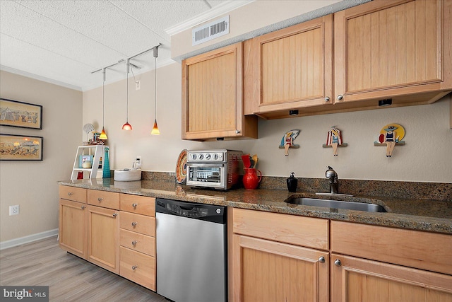 kitchen with dishwasher, sink, pendant lighting, and dark stone counters