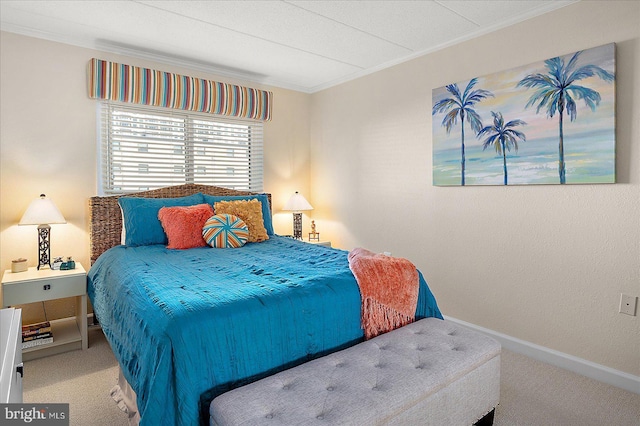 bedroom with crown molding and carpet floors