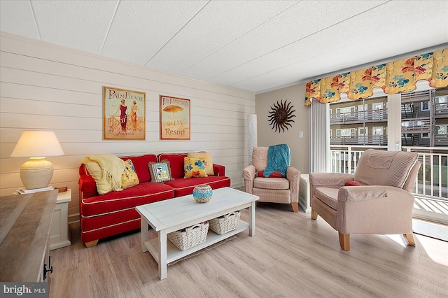 living room with wood-type flooring and a textured ceiling