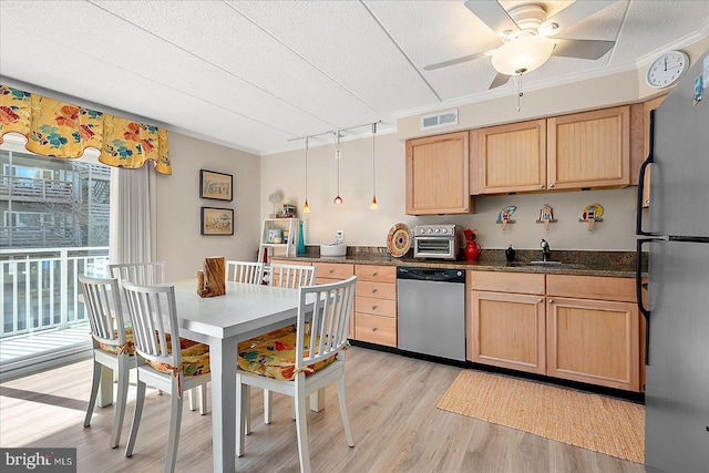 kitchen with crown molding, decorative light fixtures, light hardwood / wood-style floors, and appliances with stainless steel finishes