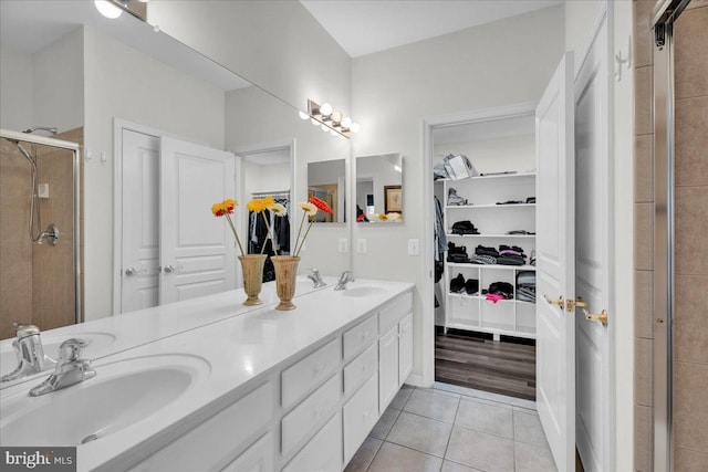 bathroom with vanity, tile patterned floors, and walk in shower