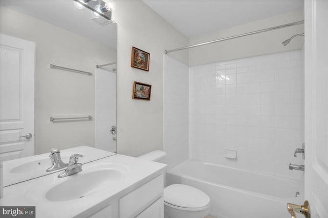 full bathroom featuring tiled shower / bath, vanity, and toilet