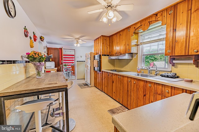 kitchen featuring tasteful backsplash, white appliances, ceiling fan, and sink