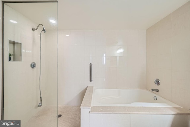 bathroom with independent shower and bath and tile walls