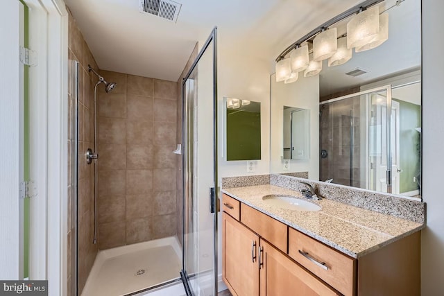 bathroom with an enclosed shower and vanity