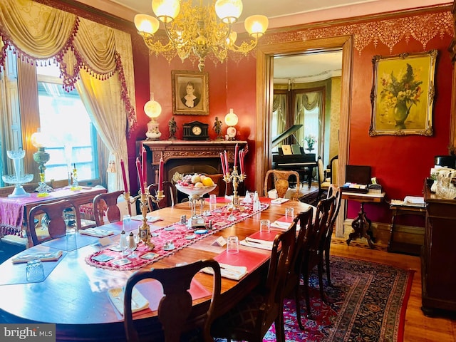 dining space with hardwood / wood-style flooring and a chandelier