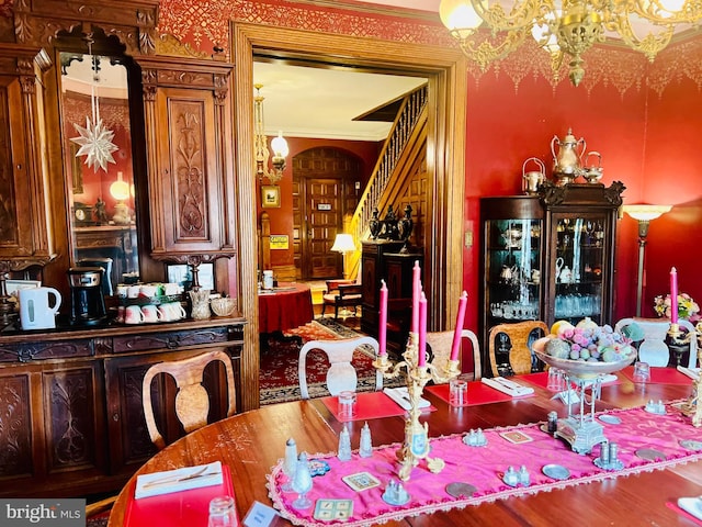 dining area featuring ornamental molding and a chandelier