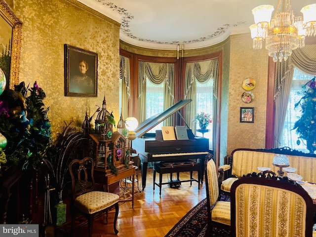 sitting room with parquet flooring and a chandelier