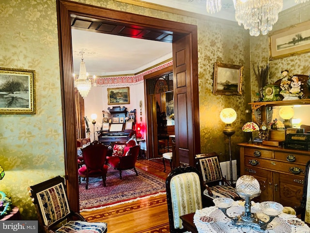 dining area featuring hardwood / wood-style floors and an inviting chandelier