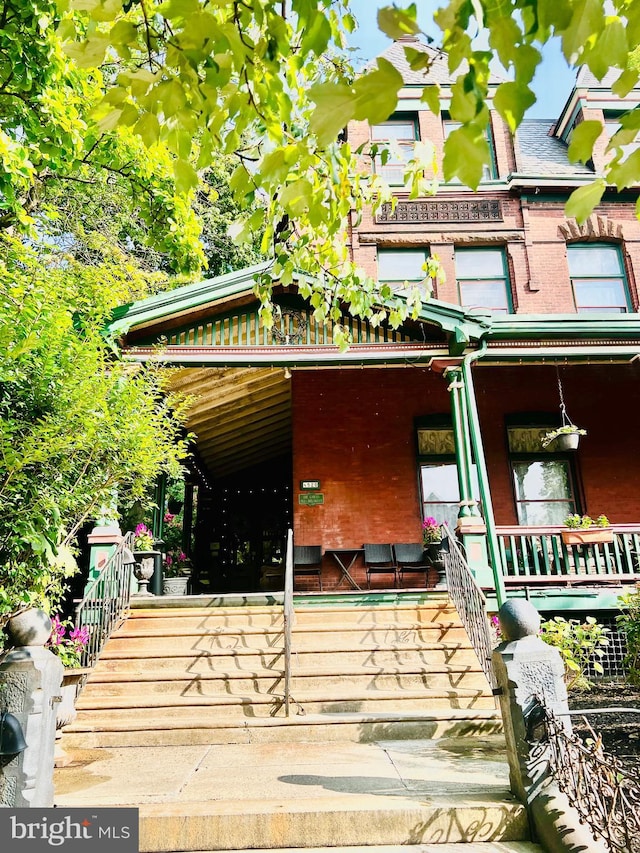 view of side of home with covered porch