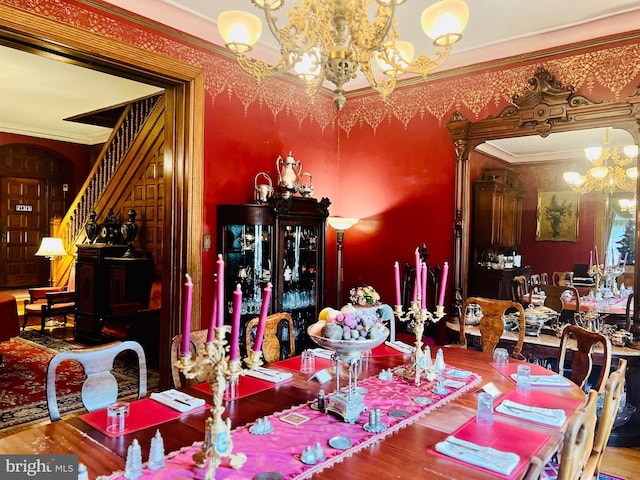 dining room with an inviting chandelier and ornamental molding