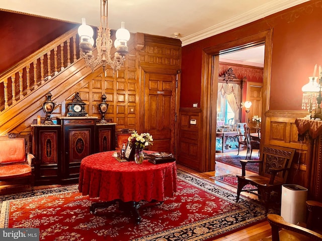 interior space with crown molding, hardwood / wood-style floors, and a chandelier