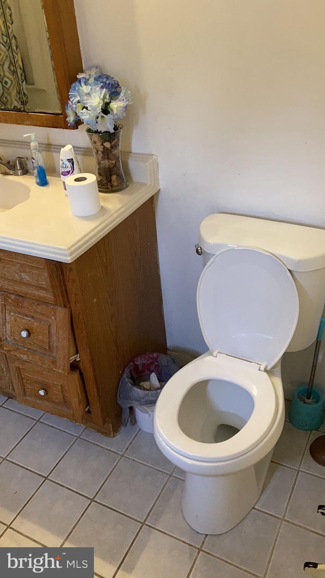 bathroom with vanity, tile patterned floors, and toilet