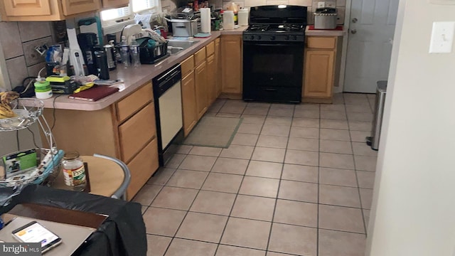 kitchen with light tile patterned flooring, dishwasher, sink, backsplash, and black gas stove