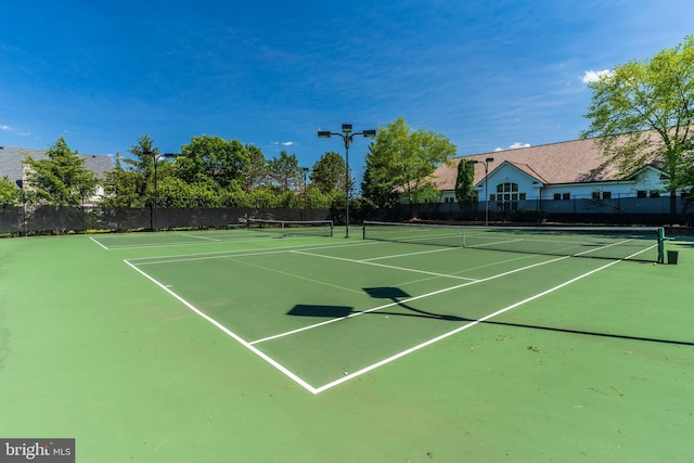 view of sport court featuring fence