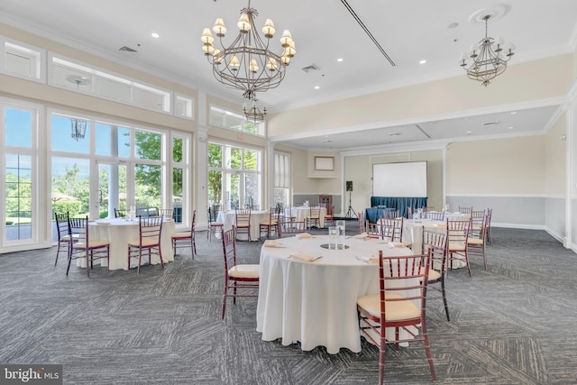 dining area featuring visible vents, a chandelier, dark carpet, and ornamental molding