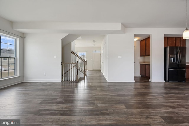 unfurnished living room with dark wood-type flooring