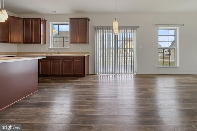 kitchen with sink, pendant lighting, and dark hardwood / wood-style flooring