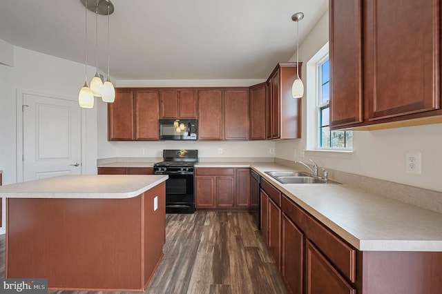 kitchen with sink, dark wood-type flooring, hanging light fixtures, black appliances, and a kitchen island