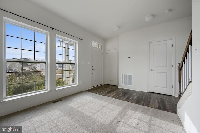 entryway with dark colored carpet