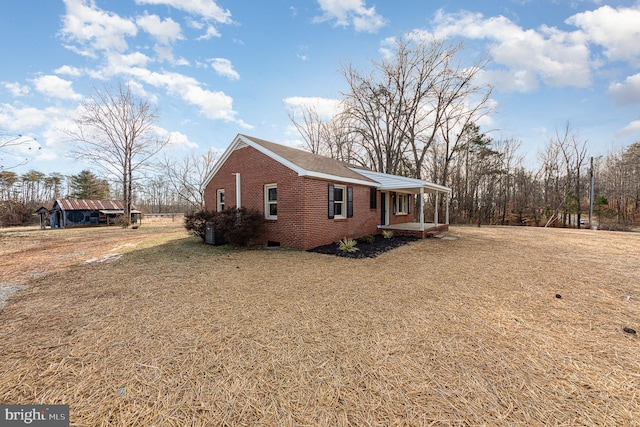 view of side of property featuring a yard and a porch