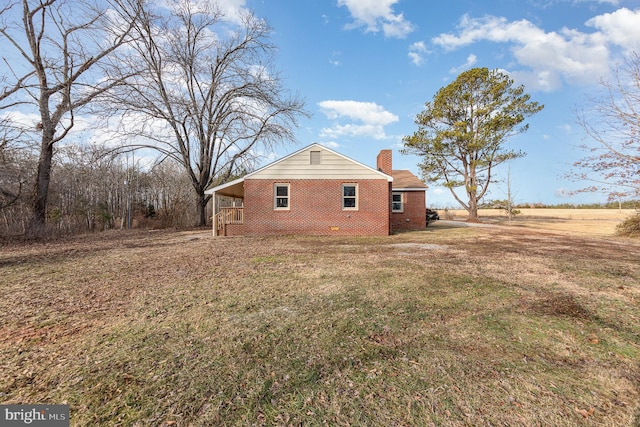 view of side of home featuring a lawn